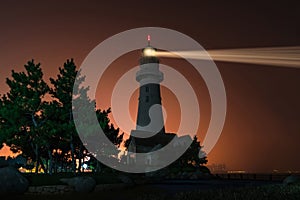 Lighthouse searchlight. Night marine embankment of Weihai