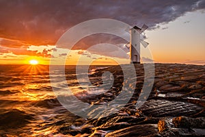 Lighthouse in the shape of a windmill in Swinoujscie in Poland during the dramatic sunset