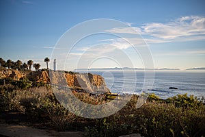 Lighthouse on the shore at sunset