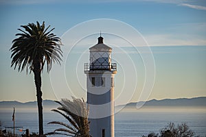 Lighthouse on the shore at sunset