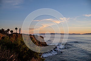 Lighthouse on the shore at sunset