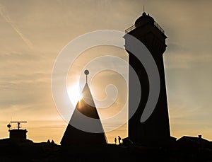 Lighthouse silhouette in sunset