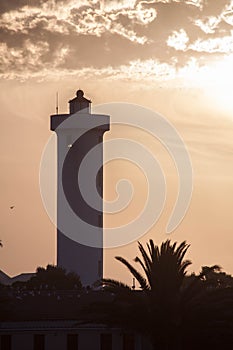 Lighthouse Silhouette at Sunset with Clouds