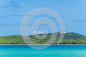 Lighthouse sits on a hill in Fajardo Puerto Rico surrounded by palm trees