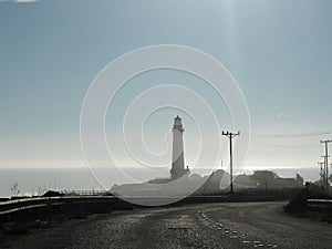 A lighthouse comes into view from the Pacific Coast highway