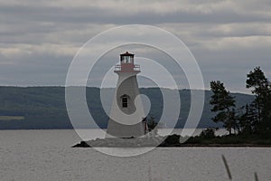 A lighthouse sitting on a point of land