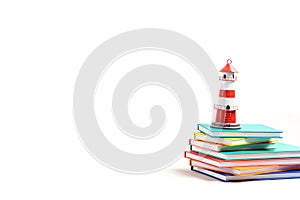 Lighthouse standing on the pile of books. International literacy day, adventures in books, imagination and travel