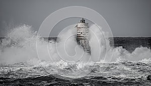Lighthouse storm - mangiabarche lighthouse during a winter swell photo