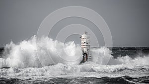 Lighthouse storm - mangiabarche lighthouse during a winter swell photo