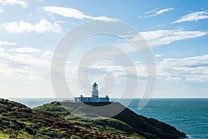 The lighthouse at Strumble Head, surrounded by the wild coastline and sea of Pembrokeshire. Wales