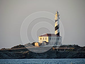 Lighthouse at Sunset in the Baeutiful Cala Tortuga in Menorca Spain