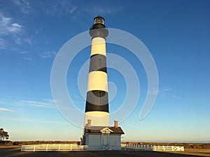 Lighthouse at sunset with a blue sky