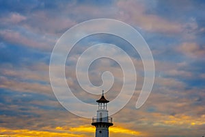 Lighthouse, sunset sky as background