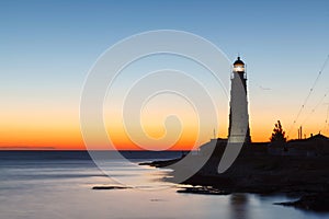 Lighthouse at sunset in the twilight in clear weather