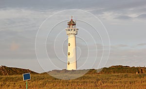 Lighthouse at sunset in the twilight. Egmond aan Zee, North Sea, the Netherlands.