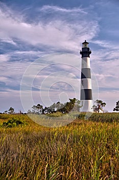 Lighthouse surrounded by clouds and marshland photo