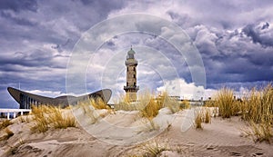 Lighthouse at the Teepott behind the dunes in WarnemÃÂ¼nde photo