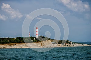 Lighthouse at the top of the hill over the sea