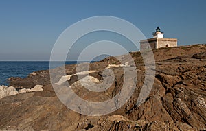 Lighthouse on top of some steep rocks typical of Cap de Creus