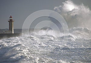 Lighthouse under big waves