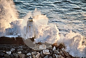 Lighthouse under the power of the waves