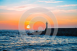 Lighthouse under sunburst