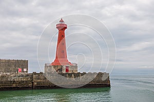 Lighthouse under sunburst