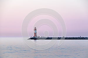 Lighthouse of the western pier at Rostock Warnemuende at twilight