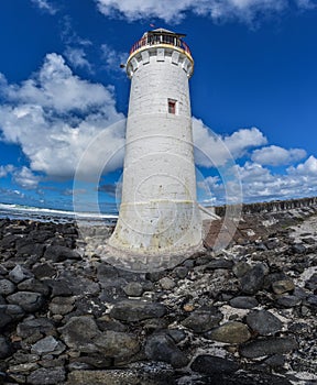 Lighthouse wide angle blue sky with clouds