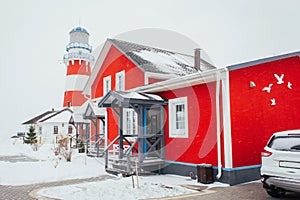 Lighthouse in winter in a fishing village, lighthouse in a blizzard