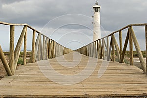Lighthouse with wooden footbridge. Fuerteventura photo