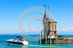 Lighthouse and yacht in harbor of Constance or Konstanz, Germany. Beautiful scenic view of Constance Lake Bodensee in summer