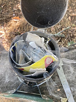 Lighting a beekeeping smoker using recycled cardboard.