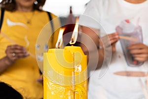 Lighting the candle pray to Buddha, big candle and Flame lit by the big candle`s fire