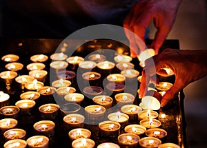 Lighting candles in a church