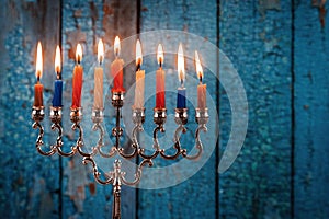 Lighting candles in menorah for Hanukkah photo