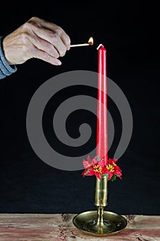 Lighting a christmas candle