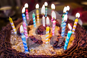 Lighting Colorful candles on birthday cake
