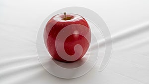 The lighting creates subtle shadows emphasizing the apple s round shape and
