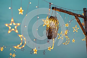 Lighting decor at party outdoors. Cozy lights lanterns, light garland background