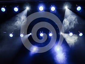 Lighting equipment on the stage. The spotlight through the smoke. Theater performance