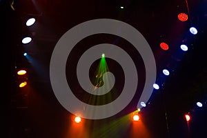 Lighting equipment on the stage of a theatre or concert hall. The rays of light from spotlights. Halogen and led light bulbs
