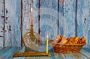 Lighting the first candle on a hanukkahof a burning Chanukah candlestick with candles Menorah