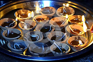 Lighting a lamp with a matchstick, Traditional clay diya lamps lit during diwali celebration, Happy Diwali