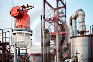 Lighting mast with lantern in explosion-proof and fire-proof design close-up over background of pipelines buildings and equipment photo