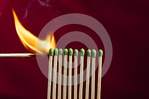 Lighting matches in a row.