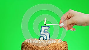 Lighting a number five birthday candle on a delicious cake, green screen 5