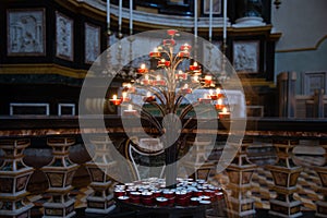 Lighting prayer candles in a church. Prayer candles in a church.