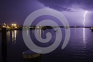 Lighting Strike Over Harbor With Purple Sky