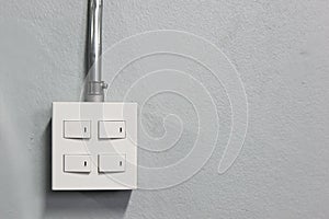 Lighting switch on grey wall